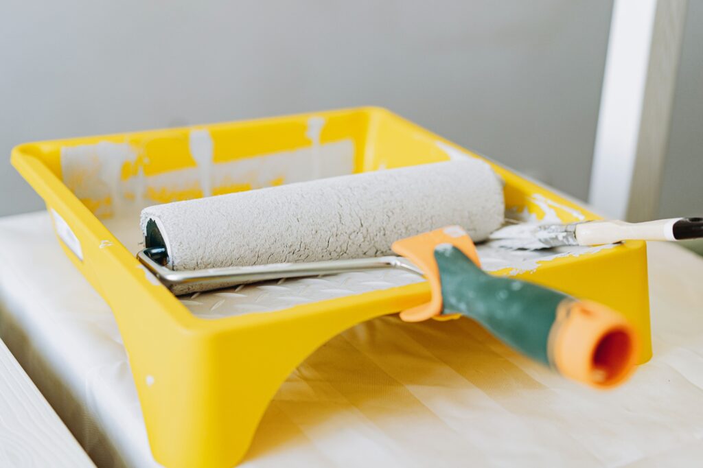 roller and brush in a tray. Renovation home concept
